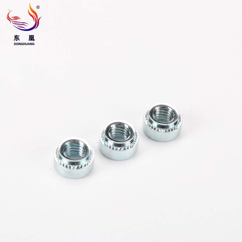 Zinc-Plated Carbon Steel Flush Self-Clinching Nut embedded in a thin metal sheet